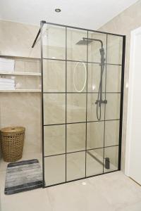 a shower with a glass door in a bathroom at Villa NOA in Jajce +21 photos