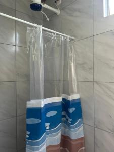 a shower curtain is hanging in a bathroom at Pousada das Redes in João Pessoa