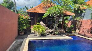 a house with a swimming pool in front of a house at Villa Intan 2 in Amed