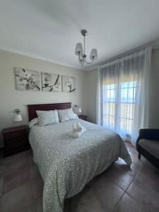 a bedroom with a bed with a teddy bear on it at Punta Brisa Marina in Punta del Caimán +55 photos