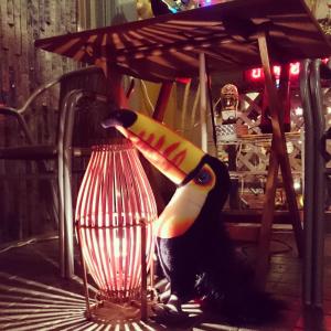 a bird with a banana sticking its head in a cage at Onomichi View Hotel Seizan in Onomichi