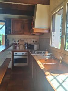 a kitchen with a sink and a stove at Maison familiale Pays Basque in Ahaxe-Alciette-Bascassan +10 photos