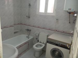 a small bathroom with a toilet and a sink at OS & MA Luxor in Luxor