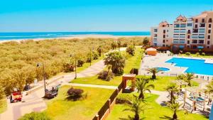 an aerial view of a resort with a pool and the beach at Punta Brisa Marina in Punta del Caimán