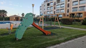 a playground with a slide in a park at Punta Brisa Marina in Punta del Caimán