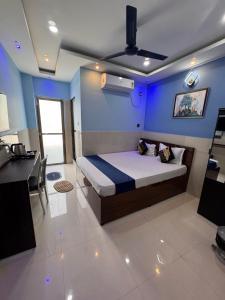 a bedroom with a bed with a blue wall at HOTEL AARNA in Tezpur