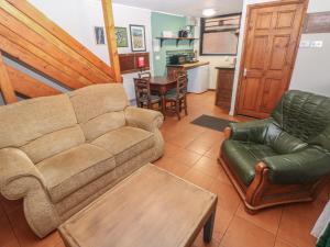 a living room with a couch and chairs and a table at Cabin No 2 - Salt and Fern Cabins in Port Talbot