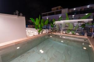 a swimming pool on top of a building at night at MUNDOBOOKING Centro Levante in Benidorm