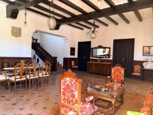 a living room with chairs and a table at La Almedina: Palacio de Foronda in Cazorla