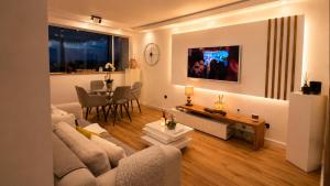 a living room with a couch and a table at Luxe-Design Imperio II- Petit Déjeuner 5min de la Mer in Praia
