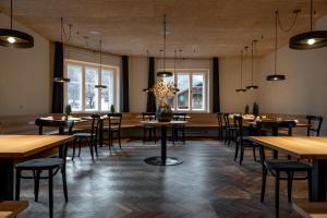 a restaurant with tables and chairs and windows at Casa al Sole in Ortisei