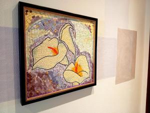 a painting of two flowers on a wall at I Mosaici Guesthouse in Ronco Scrivia