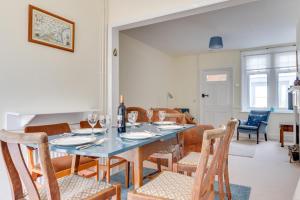 a dining room with a blue table and chairs at 3 Bed in Littlestone oc-bt009 in New Romney
