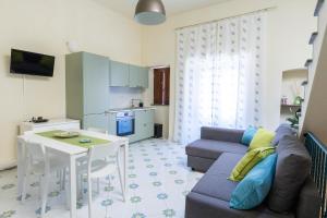 a living room with a couch and a table at Il Veliero Blu Suite Lipari Centro - Corso Vittorio Emanuele in Lipari +14 photos