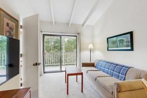 a living room with a couch and a table at Seasons 309 in Warren