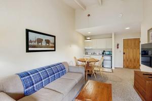 a living room with a couch and a table at Seasons 309 in Warren