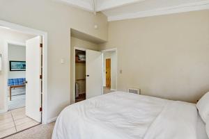 a bedroom with a white bed and a hallway at Seasons 309 in Warren +13 photos