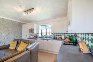 a living room with a couch and a kitchen at 3 Bed in Llanfairpwll oc-22999 in Llanfairpwllgwyngyll