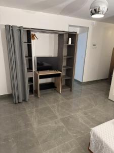 a room with a desk and shelves in a room at La Galiote in Agde