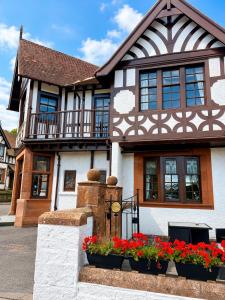 a house with flowers in front of it at The Popinjay Hotel in Larkhall