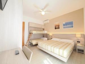 a bedroom with a bed and a bunk bed at Hotel Angelo in Caorle +60 photos
