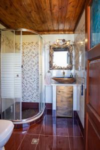 a bathroom with a sink and a shower at Lithos House in Avlóna