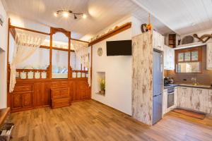 a kitchen with wooden cabinets and a refrigerator at Lithos House in Avlóna +38 photos
