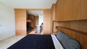 a bedroom with a bed with a wooden wall at Zantamar Riviera Nayarit at La Cruz de Huanacaxtle in Cruz de Huanacaxtle
