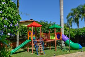 a playground with a slide in a yard at Hotel Castelo in Gravatal