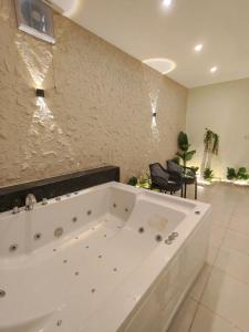 a large white bath tub in a room at Giza Pyramids Hotel in Cairo +30 photos