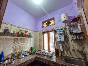 a kitchen with a sink and a counter top at Dev Palace in Uttarkāshi