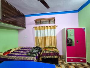 a room with two beds and a window in it at Dev Palace in Uttarkāshi