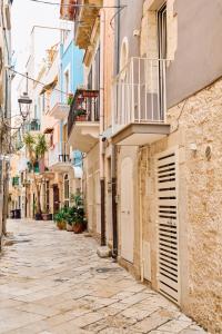 an alley in an old town with buildings at Duomo Charming Rooms in Barletta