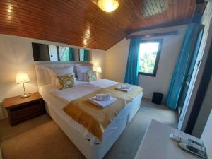 a bedroom with a bed with two towels on it at Buda Weekend House in Budapest