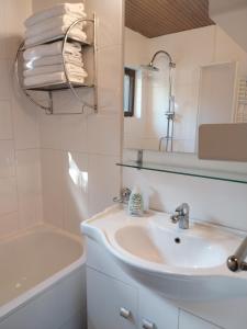 a white bathroom with a sink and a bath tub at Buda Weekend House in Budapest +24 photos