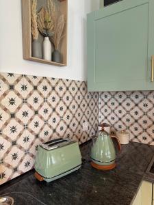 a kitchen counter with two tea pots and a toaster at Casa del Sole in Dangio +10 photos