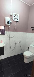 a bathroom with a toilet and a shower at IA Tiny House in Kampong Sura Tengah