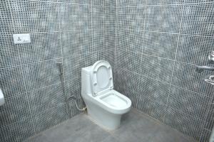 a bathroom with a toilet in a tiled stall at Nagarkot Zip Coaster Pvt Ltd in Nagarkot +24 photos