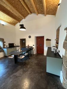 a large room with a table and chairs in it at PASENIÑO - Aloxamento rural in Palas de Rei +10 photos