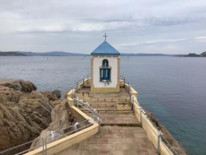 a small chapel on the edge of a body of water at Perla di mare in La Maddalena
