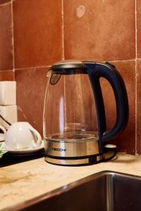 a tea kettle sitting on top of a kitchen counter at Duomo Charming Rooms in Barletta
