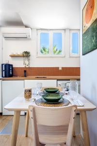 a kitchen with a table with a plate on it at Studio rénové à Palavas avec accès direct à la plage in Palavas-les-Flots