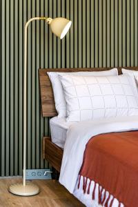 a bedroom with a bed with a lamp next to it at Studio rénové à Palavas avec accès direct à la plage in Palavas-les-Flots