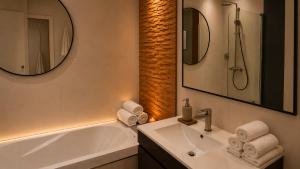 a bathroom with a sink and a tub and a mirror at Luxe-Design Imperio II- Petit Déjeuner 5min de la Mer in Praia +35 photos