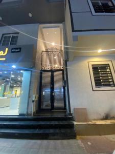 a building with a staircase in front of a store at شقة هادئة مودرن in Al Khobar +5 photos
