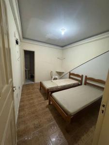 a room with two beds and a hallway at hotel vitoria in Campina Grande
