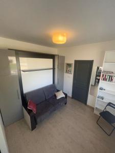 a living room with a couch in a room at Le Quai Confort T2 - in Ax-les-Thermes