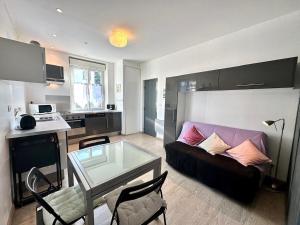 a living room with a couch and a table at Le Quai Confort T2 - in Ax-les-Thermes