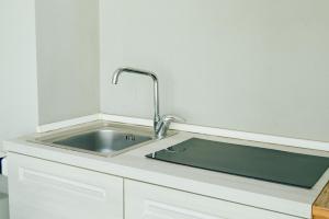 a kitchen sink with a faucet on a counter at Duomo Charming Rooms in Barletta +22 photos
