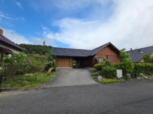 a house with a driveway in front of it at Štramberk roubenka in Štramberk